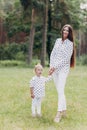 Mother with baby girl outdoors. Happy family on summer walk Mother and daughter walking in the Park and enjoying the beautiful Royalty Free Stock Photo
