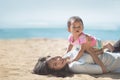 Mother and baby girl playing at seaside Royalty Free Stock Photo