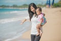 Mother and baby girl playing at seaside Royalty Free Stock Photo