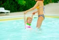 Mother and baby girl playing in swimming pool Royalty Free Stock Photo