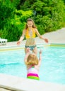 Mother and baby girl playing in swimming pool Royalty Free Stock Photo