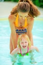 Mother and baby girl playing in swimming pool Royalty Free Stock Photo