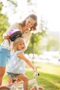 Mother and baby girl riding on bicycle Royalty Free Stock Photo