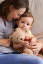 Mother, baby and happy in embrace at home, love and together for bonding in childhood. Mommy, daughter and support for