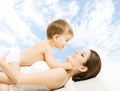 Mother baby happy playing. Child in diaper embracing mama over s