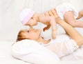 mother and baby having fun at home in the bed Royalty Free Stock Photo