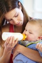 Mother, baby and holding with bottle in home of formula, feeding or hunger for future growth. Woman, infant or son with