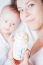 Mother and baby holding a bottle with mothers breast milk Royalty Free Stock Photo