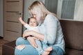 Mother and baby indoors hugging, kissing and smiling. baby happy and satisfied Royalty Free Stock Photo