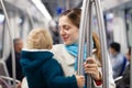 Mother with baby inside metro train