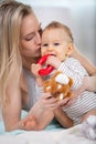 mother and baby kissing laughing and hugging