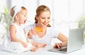 Mother and baby with a laptop and credit card