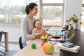 Mother with baby and laptop working at home office