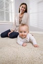 Mother with baby learning to crawl