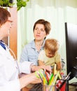 Mother with baby listening friendly doctor