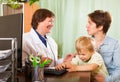 Mother with baby listening friendly pediatrician doctor