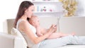 Mother and baby are looking to play and read tablet computer Royalty Free Stock Photo