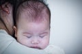 Mother and baby, Lovely asian girl resting on her mother`s shoul Royalty Free Stock Photo