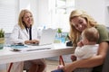 Mother And Baby Meeting With Female Doctor In Office Royalty Free Stock Photo