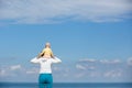 Mother and baby observing the cloudscape and sea Royalty Free Stock Photo