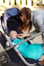 Mother, baby and pacifier in stroller for walk, together or bonding for exercise, health or wellness. Young woman