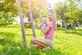 Mother with baby picking apples from an apple tree Royalty Free Stock Photo