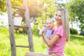 Mother with baby picking apples from an apple tree Royalty Free Stock Photo