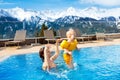 Family in outdoor swimming pool of alpine spa resort Royalty Free Stock Photo