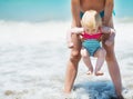 Mother and baby playing with sea waves