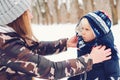 Mother and baby playing in snow. Frost winter snowy weather. Happy family on a winter walk. Winter outwear fashion Royalty Free Stock Photo