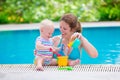 Mother and baby playing in swimming pool Royalty Free Stock Photo