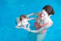 Mother and baby playing in a swimming pool Royalty Free Stock Photo