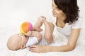 Mother and Baby Playing Toy Ball, New Born Kid Play with Mom Royalty Free Stock Photo