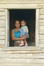 Mother and baby posing in house window in the Valle de ViÃ¯Â¿Â½ales, in central Cuba