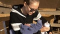 Mother and baby preparing for feeding formula sitting on bench Royalty Free Stock Photo