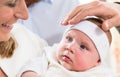 Mother, baby and priests hand at christening Royalty Free Stock Photo