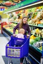 Mother with baby shopping in supermarket Royalty Free Stock Photo