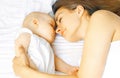 Mother and baby sleep in bed Royalty Free Stock Photo