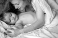 Mother and baby sleeping. Bedtime, childhood and family concept, close-up indoor portrait.