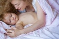 Mother and baby sleeping. Bedtime, childhood and family concept, close-up indoor portrait.