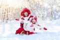 Mother and child sledding. Winter snow fun. Family on sleigh. Royalty Free Stock Photo