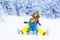 Mother and baby on sleigh ride. Winter snow fun. Royalty Free Stock Photo