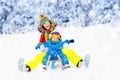 Mother and baby on sleigh ride. Winter snow fun. Royalty Free Stock Photo