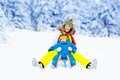 Mother and baby on sleigh ride. Winter snow fun. Royalty Free Stock Photo