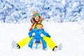 Mother and baby on sleigh ride. Winter snow fun. Royalty Free Stock Photo