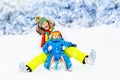 Mother and baby on sleigh ride. Winter snow fun. Royalty Free Stock Photo