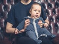 Mother and baby on sofa watching television Royalty Free Stock Photo