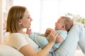 Mother and baby son smiling and playing