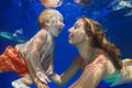 Mother, baby son swim and dive underwater in swimming pool Royalty Free Stock Photo