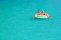 Mother, baby son swim and relax in beach club pool Royalty Free Stock Photo